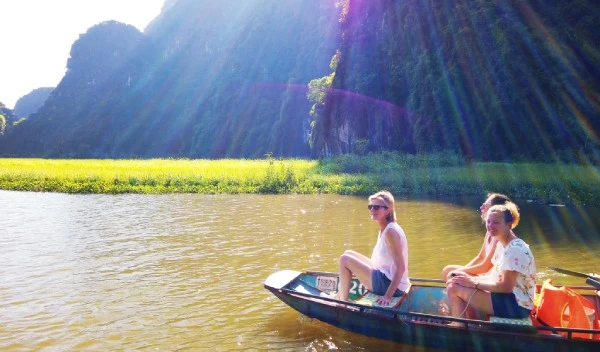 Rowboat gliding through a limestone cave on the Tam Coc river route in Ninh Binh Province